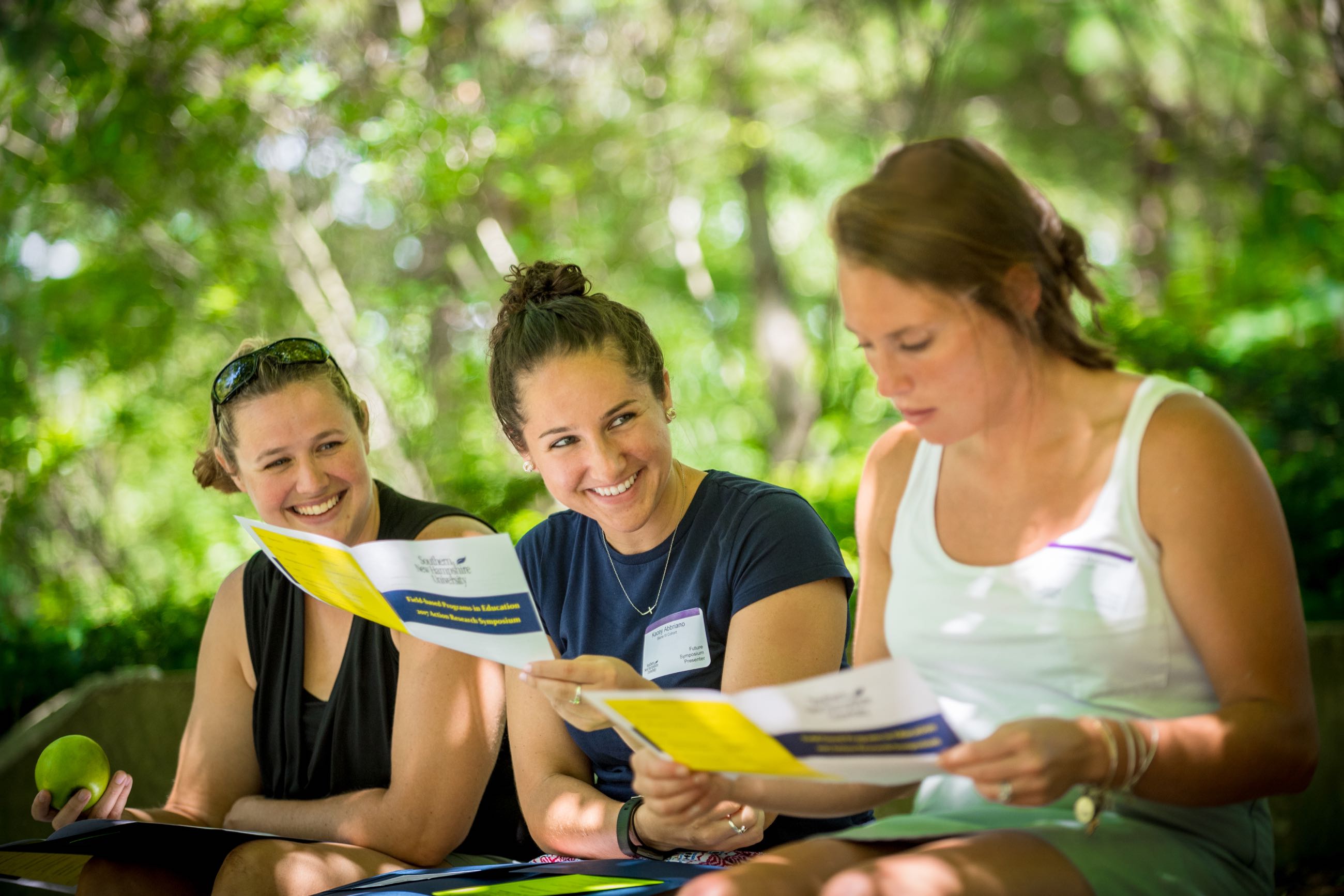 three students happily collaborating